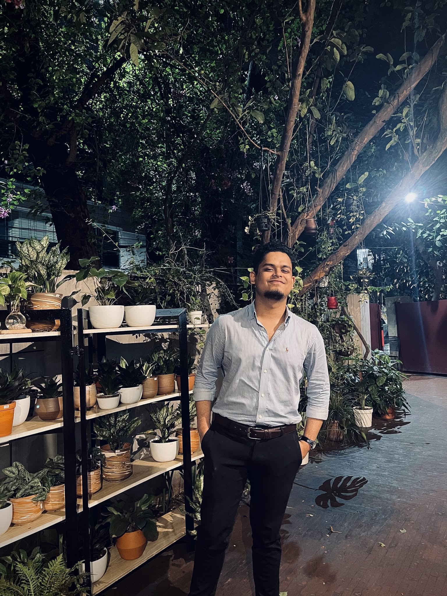 Rifat smiling during an evening meetup